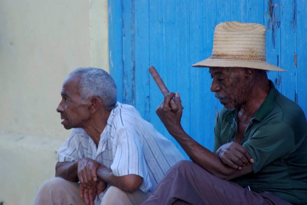 Two men by a blue door, Cuba