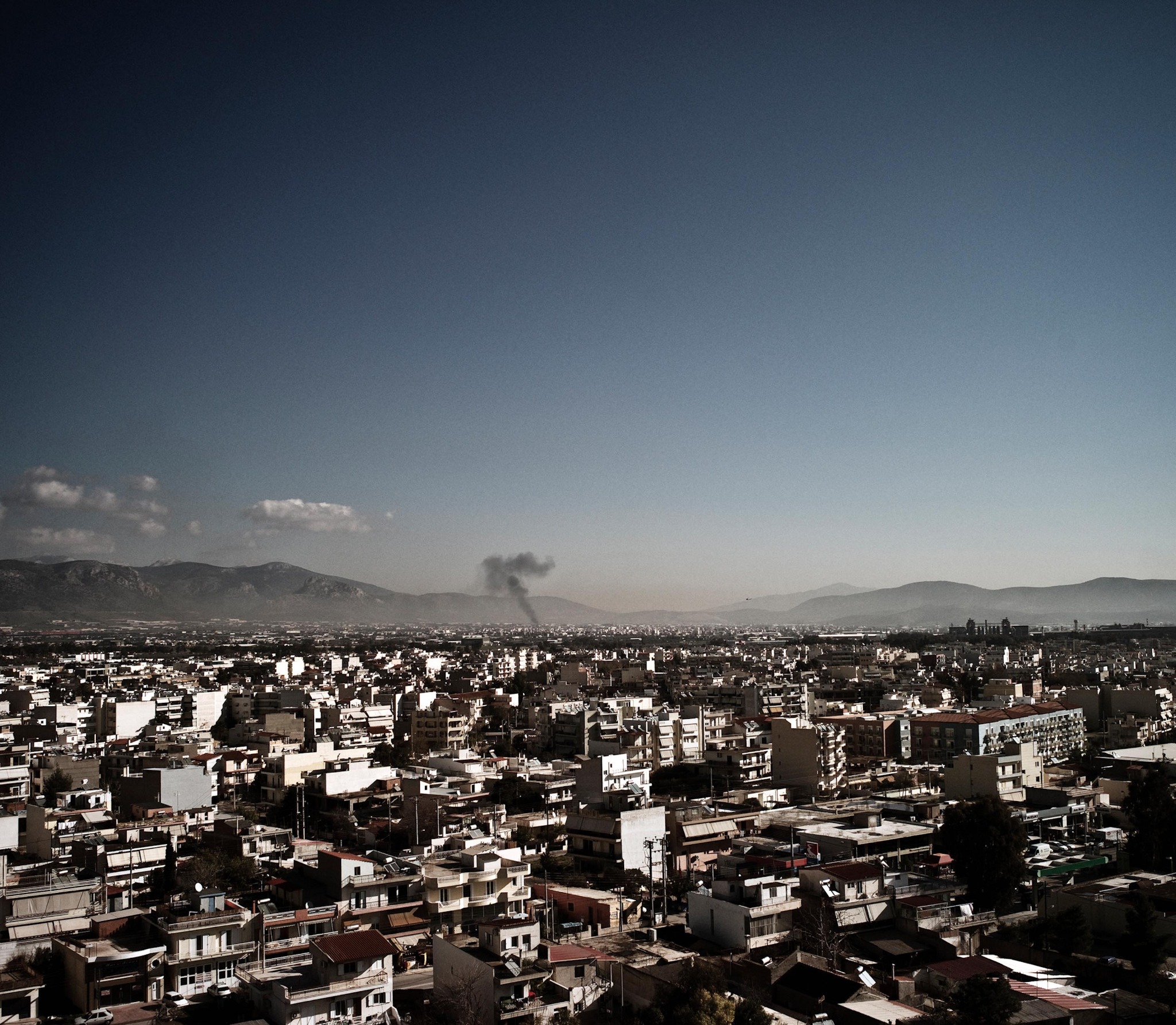Athens under a column of smoke — a still from Krisis, 2011
